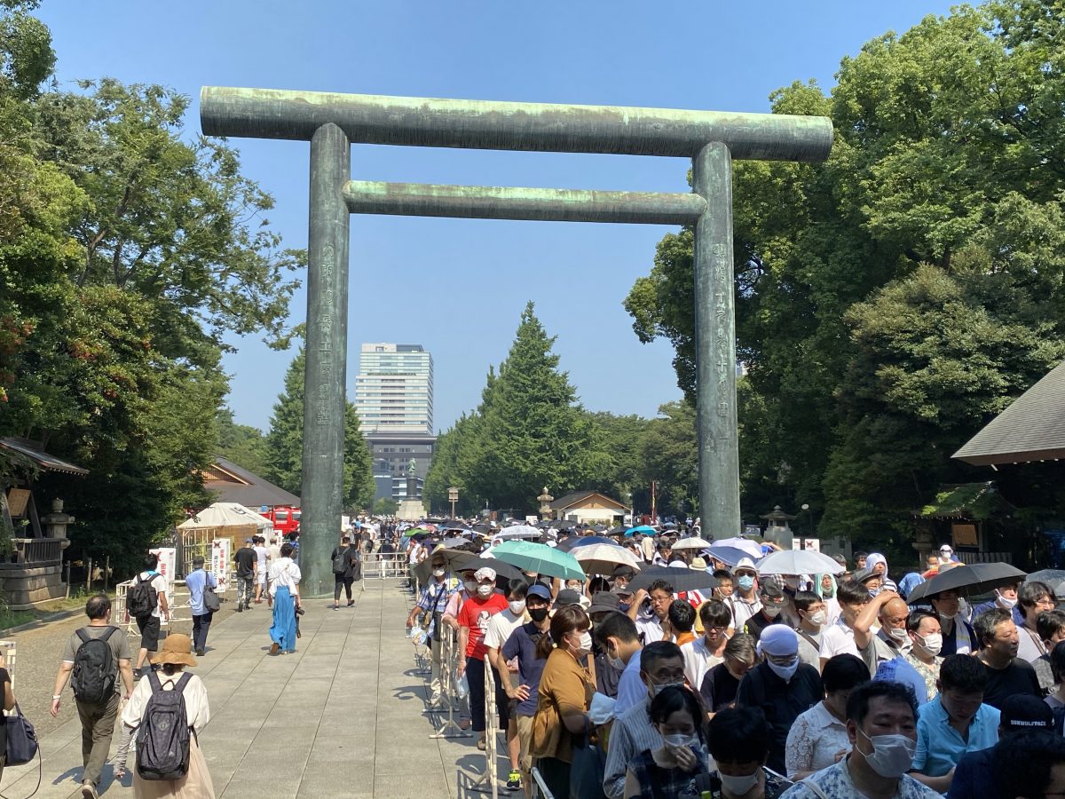Line of people waiting to make a pilgrimmage at the shrine marking the end of WWII